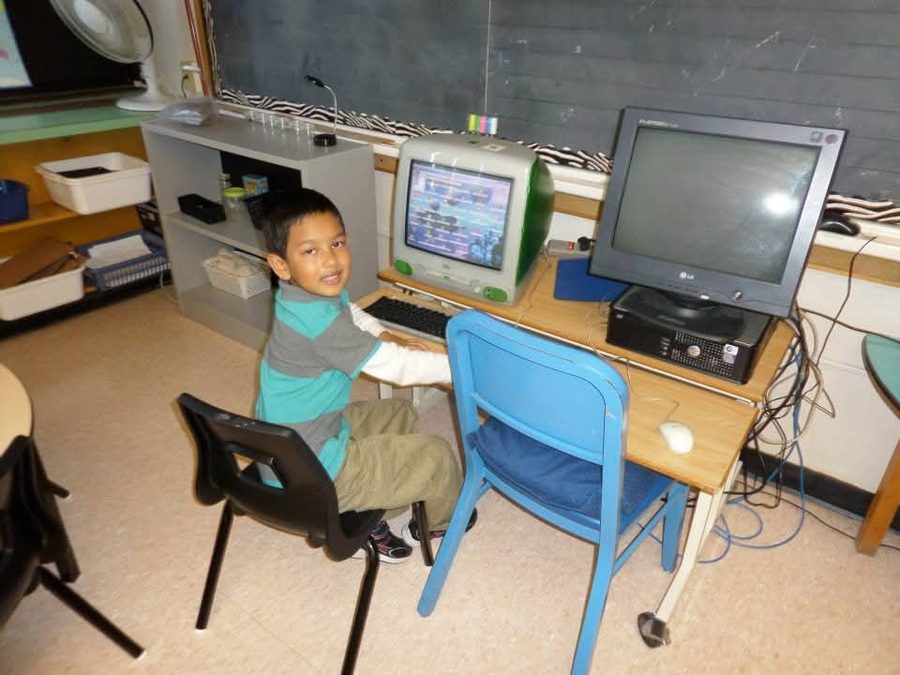 Ahnaf as a young child at a classroom computer