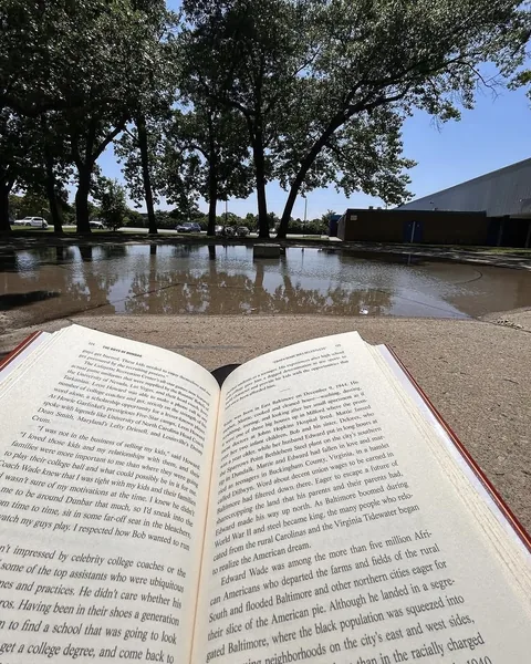 An open copy of The Boys of Dunbar outside on a sunny day