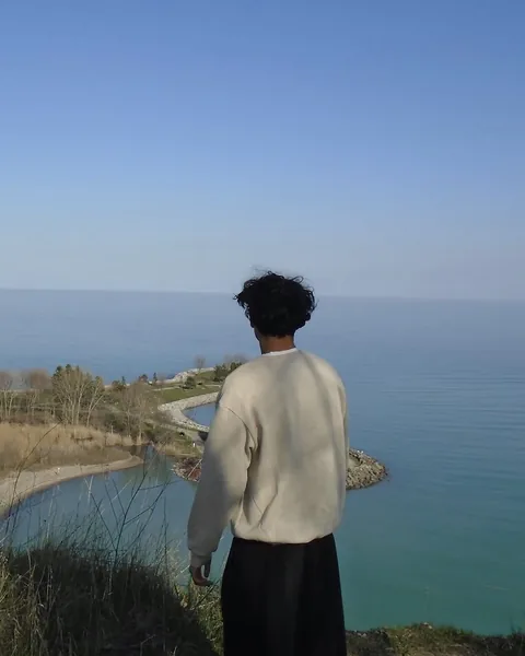 Ahnaf looking out over Lake Ontario from a cliff