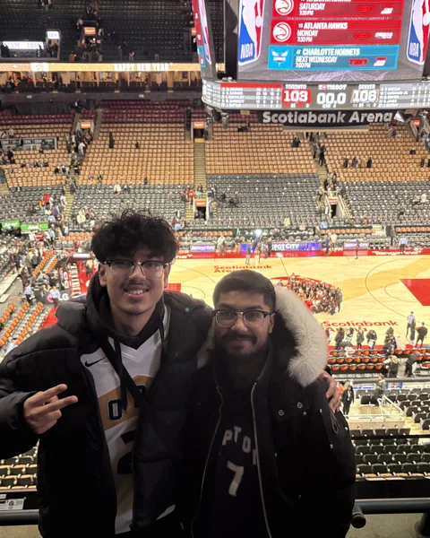 Ahnaf and a friend at a Raptors game at Scotiabank Arena